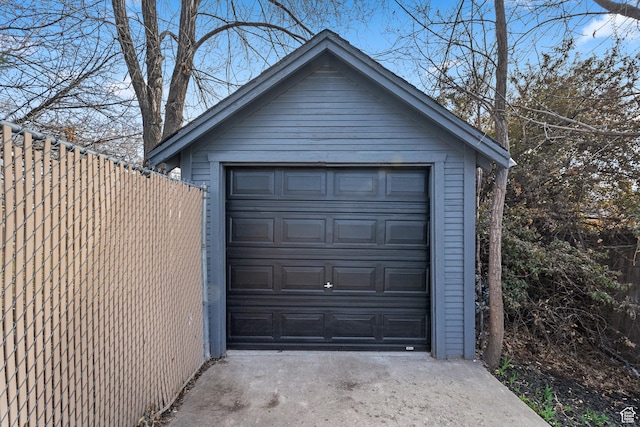 detached garage with driveway and fence