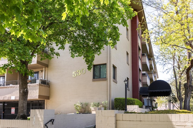 view of apartment building / complex with fence