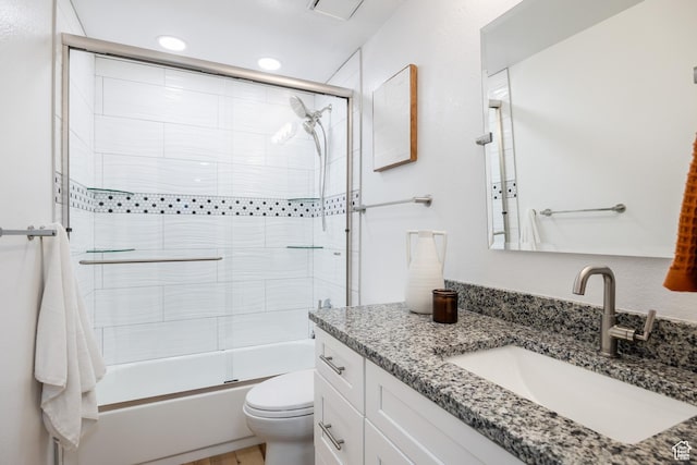 full bathroom with toilet, vanity, combined bath / shower with glass door, and recessed lighting