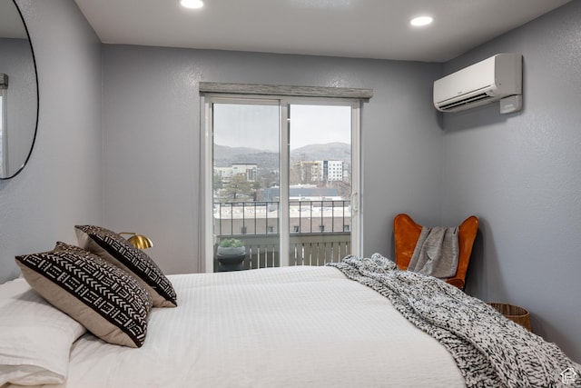 bedroom with a wall mounted AC, access to outside, and recessed lighting