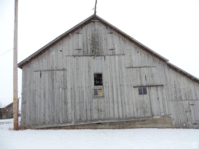 snow covered structure with an outdoor structure