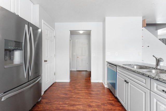 74 E Horizon Ave S, Heber City, UT 84032 - kitchen with light stone counters, stainless steel appliances, dark wood-style flooring, a sink, and white cabinetry