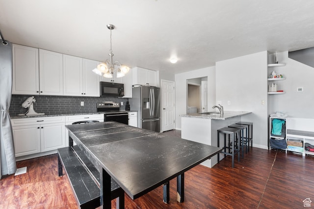 74 E Horizon Ave S, Heber City, UT 84032 - kitchen with a peninsula, white cabinets, stainless steel appliances, and dark wood-style flooring