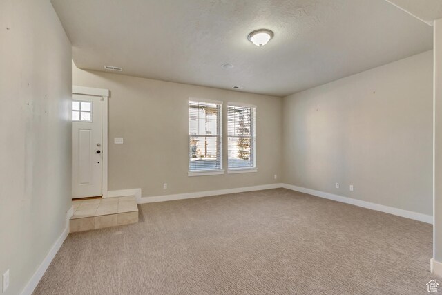 1972 Grant Ave, Ogden, UT 84401 - spare room with visible vents, baseboards, and light colored carpet