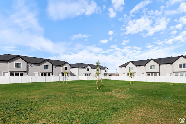 view of yard featuring a residential view and fence