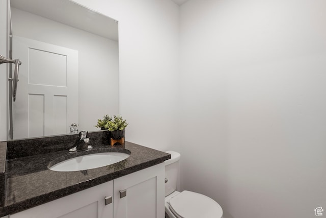 half bath with vanity and toilet