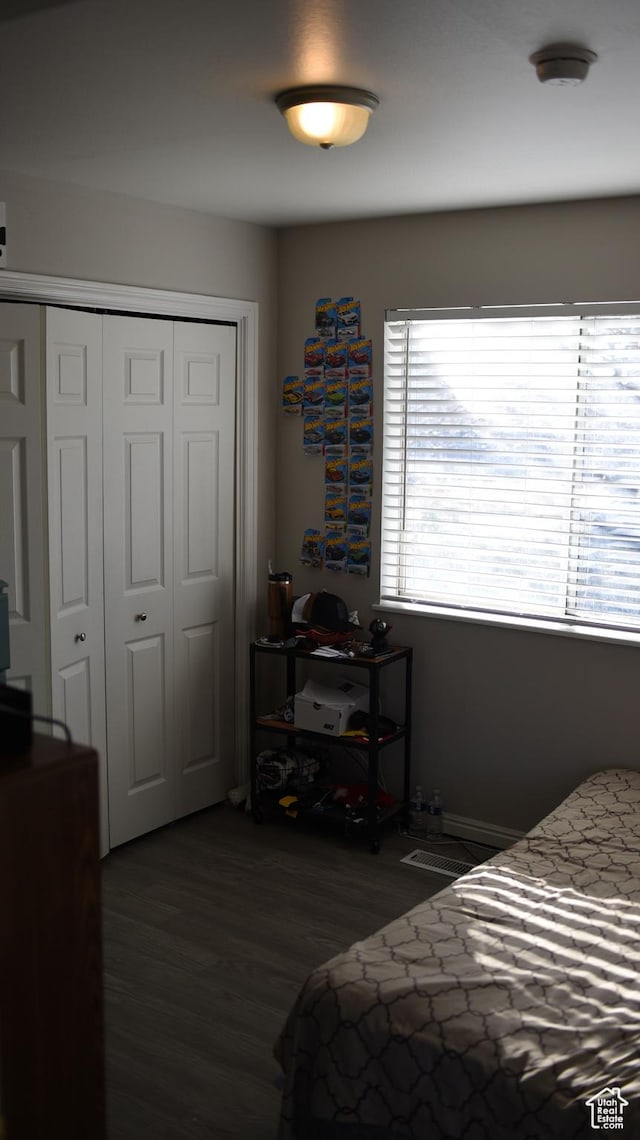 bedroom with a closet and wood finished floors