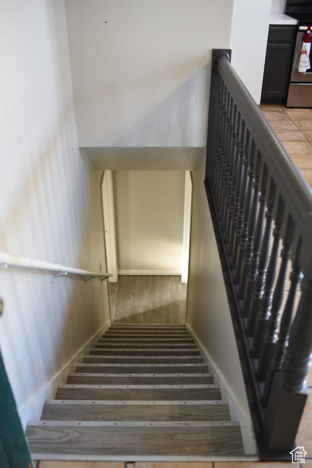 staircase with wood finished floors