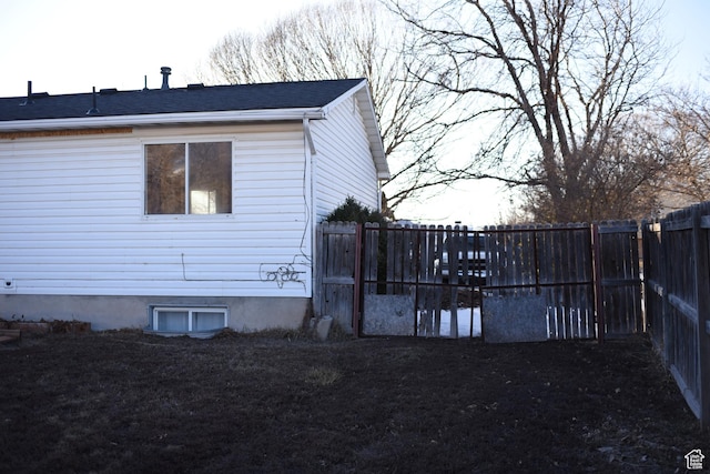 view of side of home featuring a fenced backyard