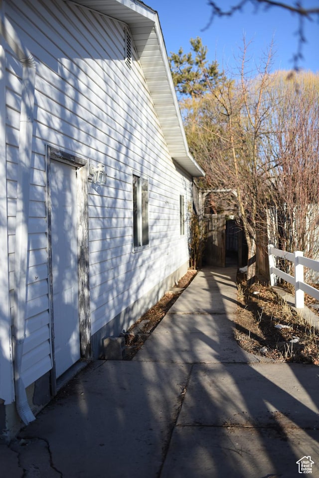 view of property exterior featuring fence and a gate