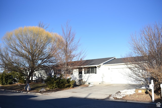 ranch-style home featuring driveway and a garage