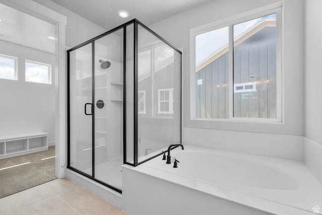 bathroom featuring a stall shower, tile patterned floors, a bath, and recessed lighting