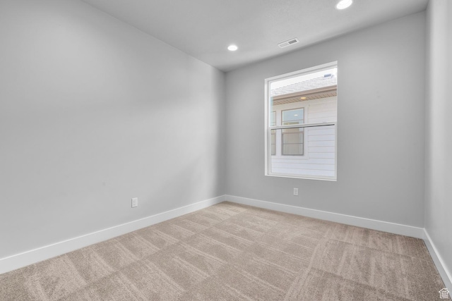 spare room featuring baseboards, visible vents, carpet flooring, and recessed lighting