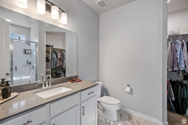 5715 Brambling Way E, Stansbury Park, UT 84074 - bathroom featuring toilet, a stall shower, vanity, baseboards, and visible vents