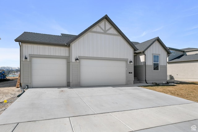 5715 Brambling Way E, Stansbury Park, UT 84074 - modern farmhouse style home with board and batten siding, an attached garage, concrete driveway, and roof with shingles