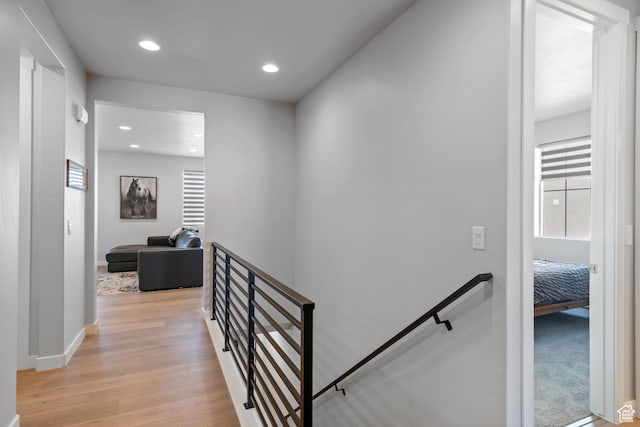 5715 Brambling Way E, Stansbury Park, UT 84074 - hall featuring baseboards, an upstairs landing, light wood-type flooring, and recessed lighting