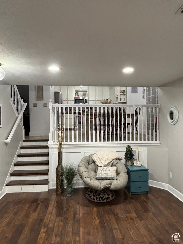 living area with recessed lighting, stairway, baseboards, and wood finished floors