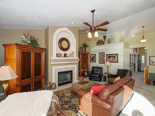 121 E Amber Rd, Saratoga Springs, UT 84045 - carpeted living area with a ceiling fan, a tiled fireplace, and a textured ceiling