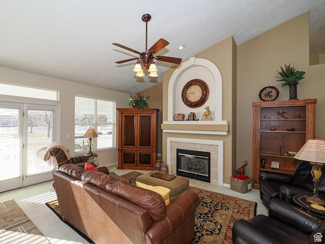 121 E Amber Rd, Saratoga Springs, UT 84045 - living room featuring lofted ceiling, a ceiling fan, a tiled fireplace, light colored carpet, and baseboards