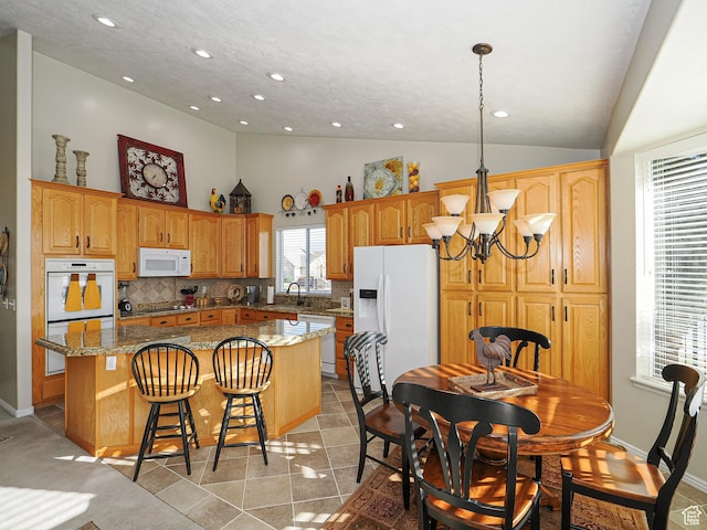 121 E Amber Rd, Saratoga Springs, UT 84045 - kitchen with white appliances, a kitchen island, recessed lighting, tasteful backsplash, and a sink