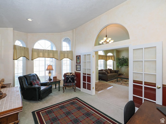 121 E Amber Rd, Saratoga Springs, UT 84045 - carpeted living room featuring french doors, a chandelier, and a high ceiling