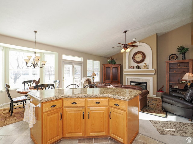 121 E Amber Rd, Saratoga Springs, UT 84045 - kitchen featuring a chandelier, vaulted ceiling, healthy amount of natural light, a tiled fireplace, and ceiling fan