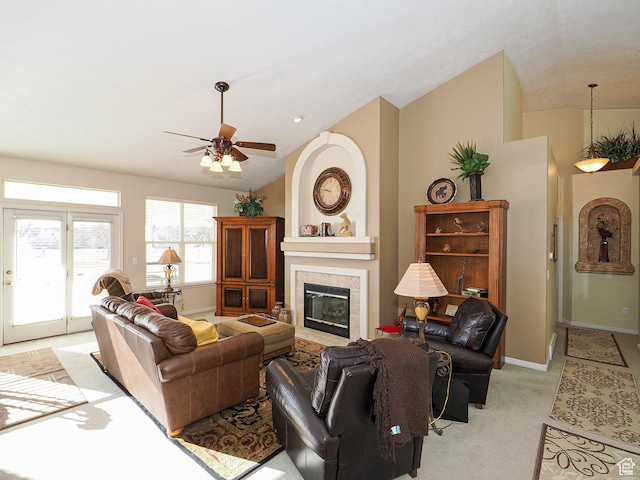 121 E Amber Rd, Saratoga Springs, UT 84045 - living area featuring vaulted ceiling, a tiled fireplace, a ceiling fan, light colored carpet, and baseboards