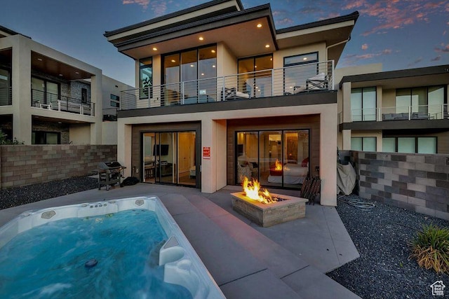 1478 W Torrey Rd, Hurricane, UT 84737 - rear view of property with a patio, an outdoor fire pit, an outdoor hot tub, and stucco siding