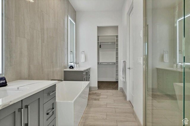 1478 W Torrey Rd, Hurricane, UT 84737 - full bathroom with a stall shower, a soaking tub, two vanities, a spacious closet, and a sink