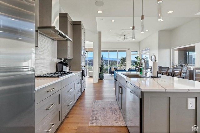 1478 W Torrey Rd, Hurricane, UT 84737 - kitchen featuring stainless steel appliances, a sink, wall chimney range hood, and gray cabinetry
