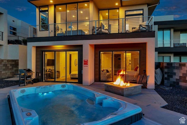 1478 W Torrey Rd, Hurricane, UT 84737 - rear view of property with an outdoor hot tub and stucco siding