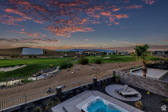 1478 W Torrey Rd, Hurricane, UT 84737 - pool at dusk with a mountain view, an outdoor hot tub, and fence