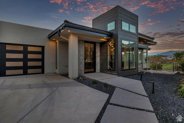 1478 W Torrey Rd, Hurricane, UT 84737 - doorway to property featuring a garage, stone siding, and concrete driveway