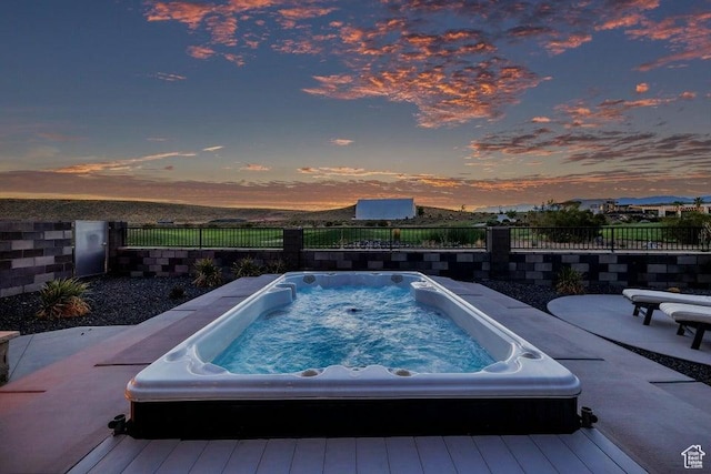 1478 W Torrey Rd, Hurricane, UT 84737 - pool at dusk featuring hot tub deck surround and fence