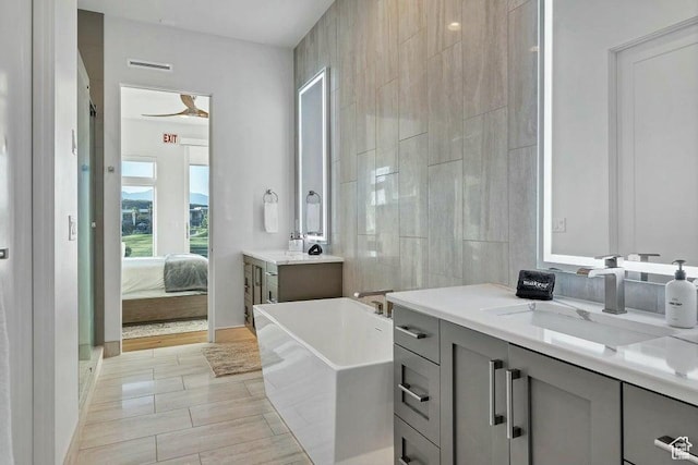 1478 W Torrey Rd, Hurricane, UT 84737 - ensuite bathroom with tile walls, a soaking tub, visible vents, ensuite bathroom, and vanity