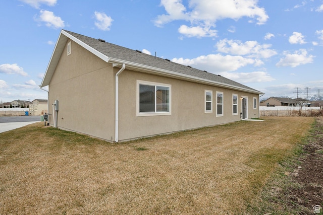 3361 W Sophie Ln, West Haven, UT 84401 - rear view of house with a yard, stucco siding, and fence