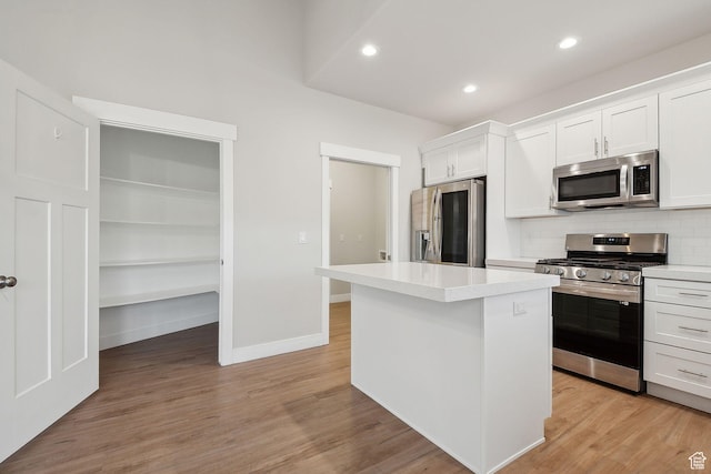 3361 W Sophie Ln, West Haven, UT 84401 - kitchen featuring light wood finished floors, light countertops, decorative backsplash, white cabinets, and stainless steel appliances
