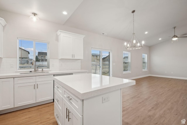 3361 W Sophie Ln, West Haven, UT 84401 - kitchen with light wood-type flooring, a sink, tasteful backsplash, light countertops, and vaulted ceiling