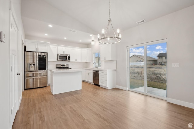 3361 W Sophie Ln, West Haven, UT 84401 - kitchen with visible vents, an inviting chandelier, light wood-style flooring, a sink, and stainless steel appliances