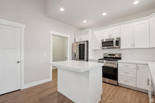 3361 W Sophie Ln, West Haven, UT 84401 - kitchen with white cabinets, light wood-type flooring, backsplash, and stainless steel appliances