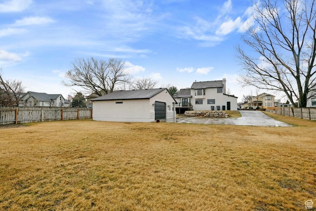 9971 S Dunsinane Dr W, South Jordan, UT 84009 - back of house with a patio, a yard, fence, an outdoor structure, and stucco siding