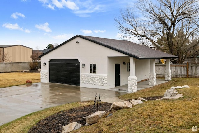 9971 S Dunsinane Dr W, South Jordan, UT 84009 - view of property exterior with a garage, fence, stone siding, concrete driveway, and stucco siding