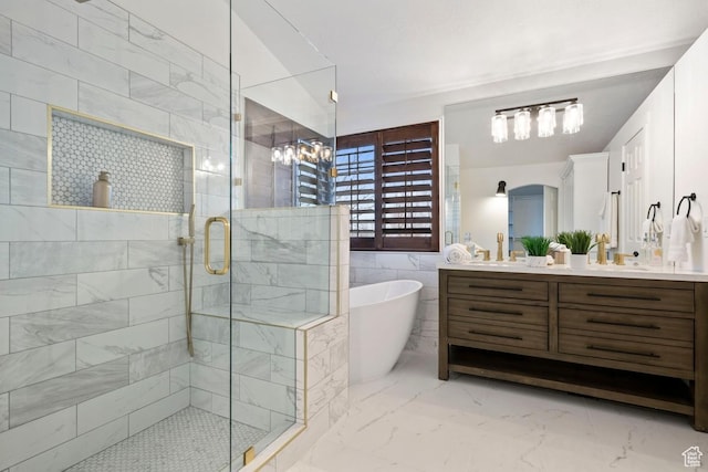 9971 S Dunsinane Dr W, South Jordan, UT 84009 - bathroom with marble finish floor, tile walls, a soaking tub, a shower stall, and vanity