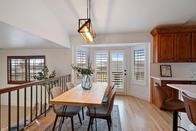 9971 S Dunsinane Dr W, South Jordan, UT 84009 - dining space with lofted ceiling, light wood finished floors, and baseboards