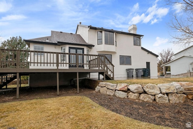 9971 S Dunsinane Dr W, South Jordan, UT 84009 - back of property with stairs, a chimney, a deck, and stucco siding