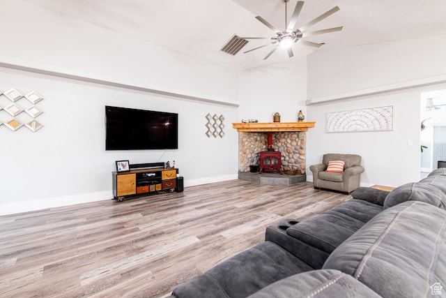 1027 S 920 W, Hurricane, UT 84737 - living room featuring ceiling fan, wood finished floors, a wood stove, and baseboards