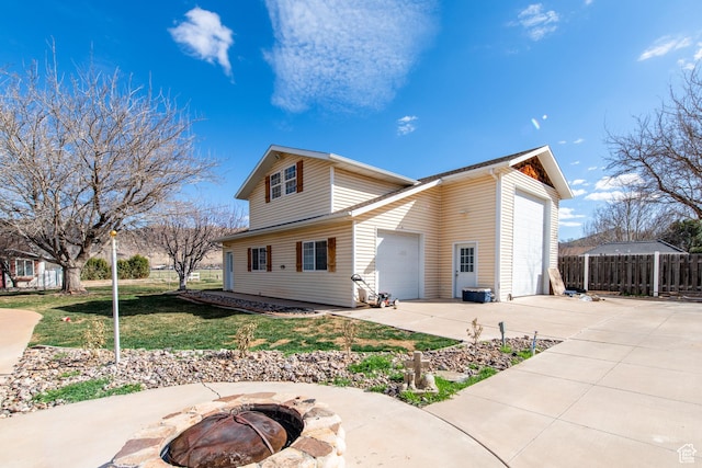1027 S 920 W, Hurricane, UT 84737 - back of house featuring a garage, a yard, fence, and a fire pit