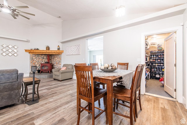 1027 S 920 W, Hurricane, UT 84737 - dining room featuring vaulted ceiling, light wood finished floors, a wood stove, and a ceiling fan