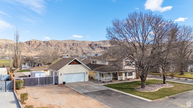 1027 S 920 W, Hurricane, UT 84737 - view of front of home with concrete driveway, a gate, fence, a mountain view, and a front yard
