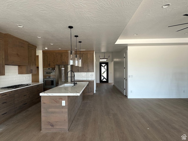 579 S 1800 W, Hurricane, UT 84737 - kitchen with dark wood-type flooring, appliances with stainless steel finishes, an island with sink, and decorative backsplash
